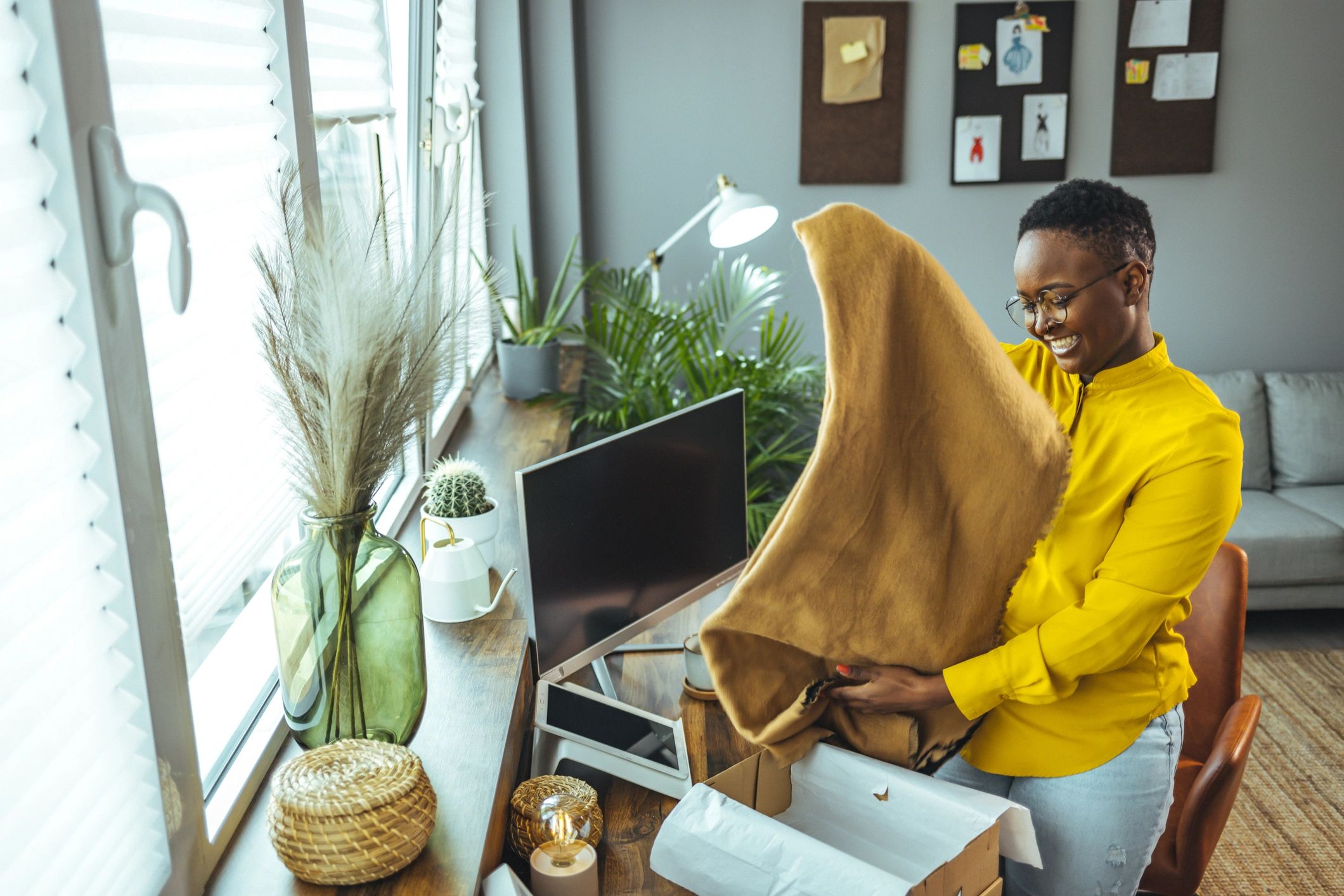 About Happy customer opening a delivered package at home
