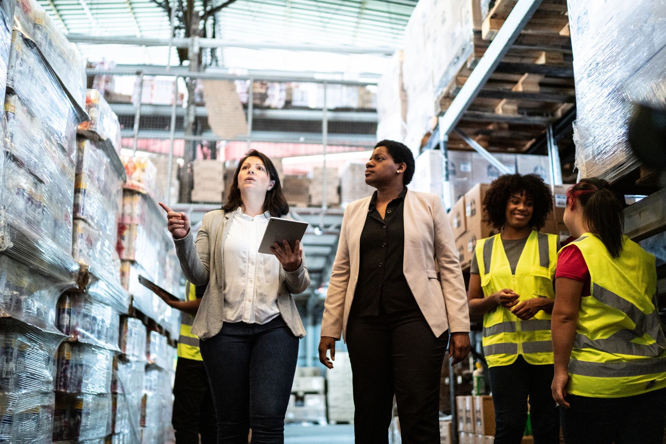 Coworkers walking and talking in a warehouse
