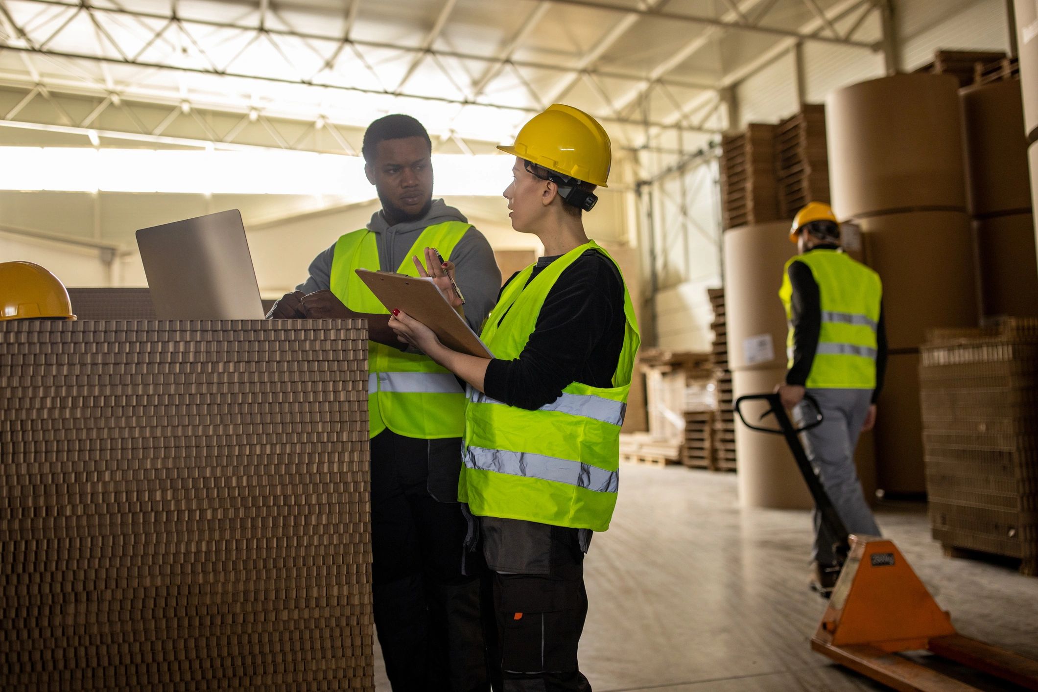 Warehouse team using a laptop to coordinate orders